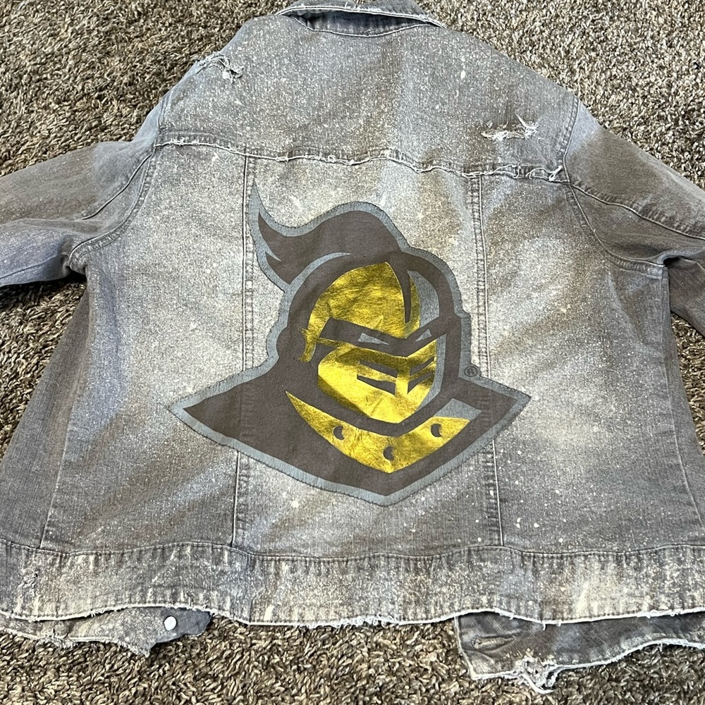Women’s distressed UCF jean jacket